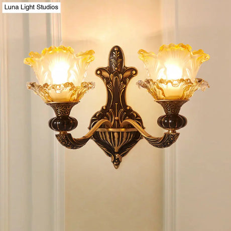 Rustic Half-Head Wall Lamp With Curvy Metallic Design And Flower Amber Glass Shade - Brass Finish