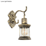 Rustic Wall Mounted Kerosene Light Fixture With Carved Pattern - Aged Bronze Finish Clear Glass