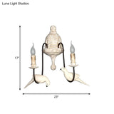 Rustic Wood Swooping Arm Wall Lamp With Distressed White Sconce - Decorative Candle And Bird Accents