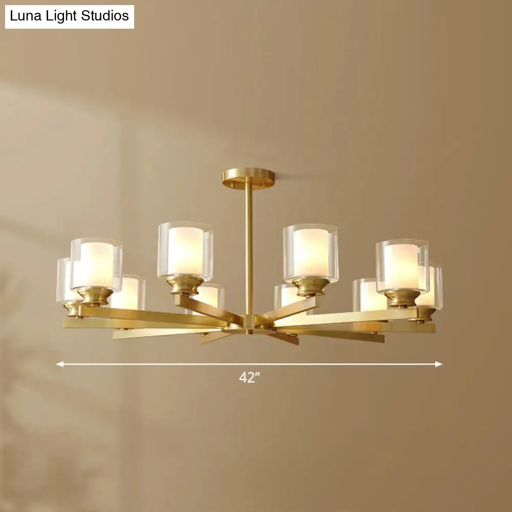 Sleek Brass Cylindrical Hanging Lamp With Clear And Frosted Glass Minimalistic Dining Room