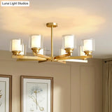 Sleek Brass Cylindrical Hanging Lamp With Clear And Frosted Glass Minimalistic Dining Room