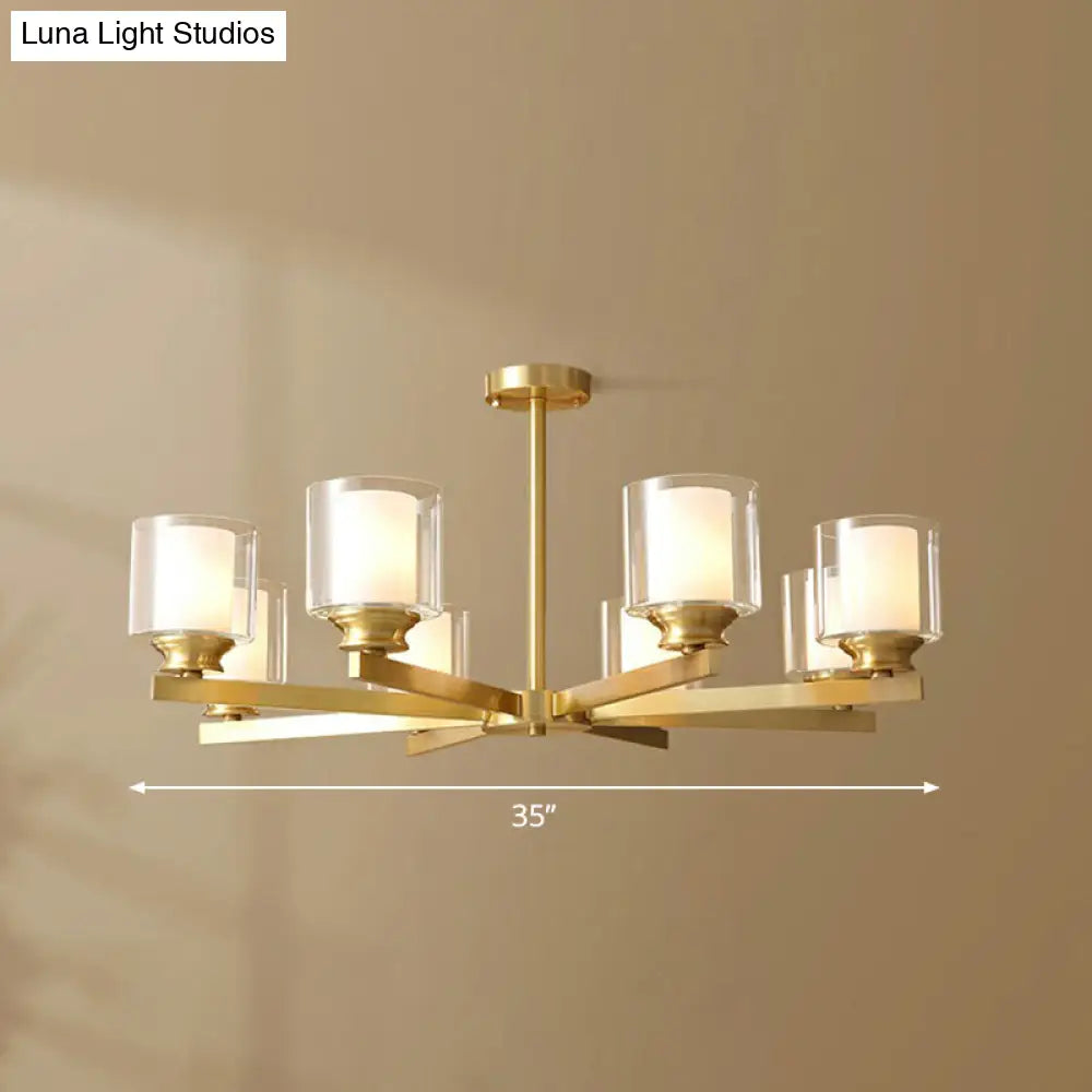 Sleek Brass Cylindrical Hanging Lamp With Clear And Frosted Glass Minimalistic Dining Room