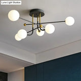Sleek Cream Glass Ball Semi Mount Ceiling Light With Minimalistic Black And Brass Accents For Dining