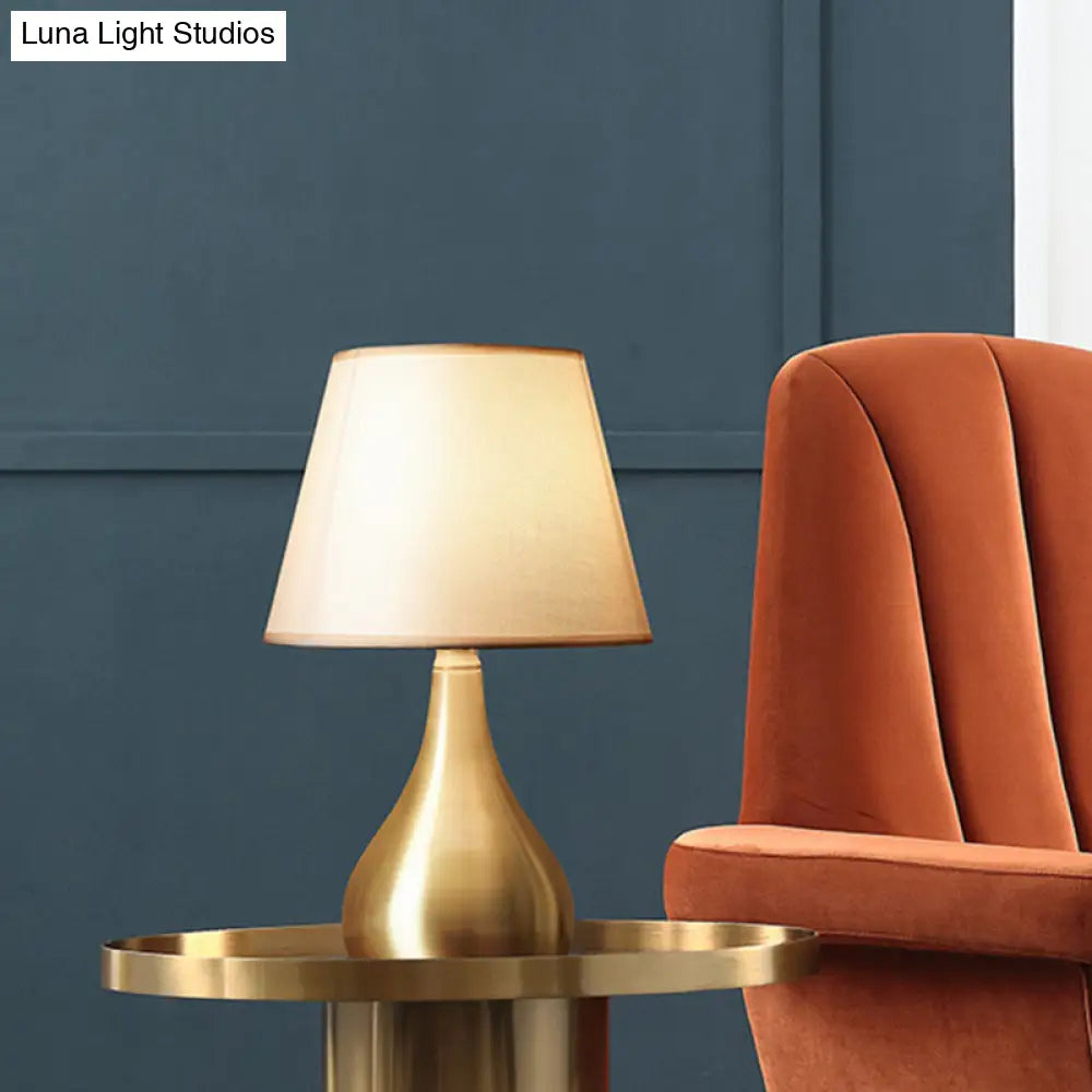 Sleek Metallic Urn-Shape Table Light - Simplicity 1-Light Brass Finish Lamp With Barrel Fabric Shade
