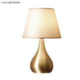 Sleek Metallic Urn-Shape Table Light - Simplicity 1-Light Brass Finish Lamp With Barrel Fabric Shade