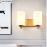 Traditional 2-Bulb Gold Wall Lamp With Milky Glass Cylindrical Fixture