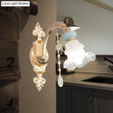 Traditional Blue Frosted Glass Wall Sconce With Ceramic Accent And Ruffle Trim