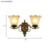 Traditional Brass Floral Wall Lamp With Frosted Glass And Carved Backplate