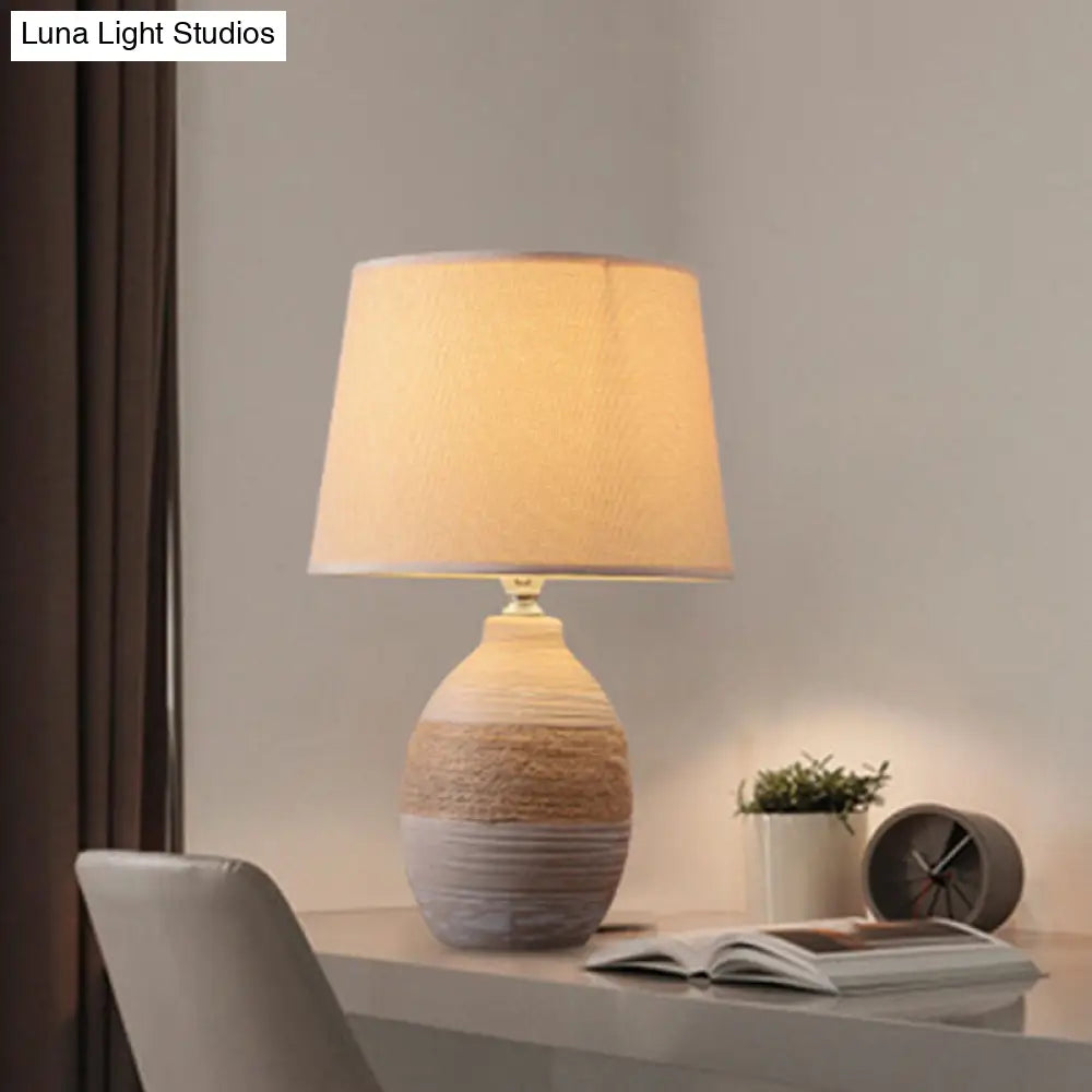 Traditional Flaxen/Grey Nightstand Lamp With Ceramic Base - 1-Light Fabric Drum Desk Light