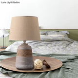 Traditional Flaxen/Grey Nightstand Lamp With Ceramic Base - 1-Light Fabric Drum Desk Light