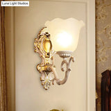 Vintage Brass/Beige Frosted Ribbed Glass Wall Sconce Lamp With Curvy Arm - 1 Light Bloom