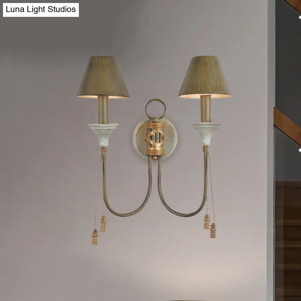 Vintage Iron Swooping Arm Sconce Light - Gold Wall Mount Lamp With Tapered Shade And Carved Spike