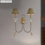 Vintage Iron Swooping Arm Sconce Light - Gold Wall Mount Lamp With Tapered Shade And Carved Spike