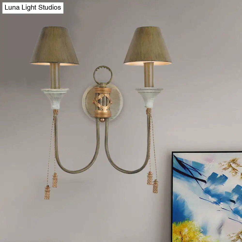 Vintage Iron Swooping Arm Sconce Light - Gold Wall Mount Lamp With Tapered Shade And Carved Spike