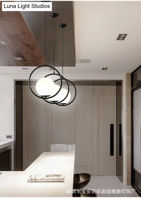 White Glass Pendant Light With Mid-Century Globe Design And Metal Ring